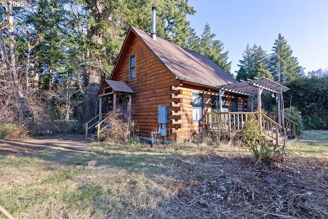view of home's exterior featuring a pergola and log exterior