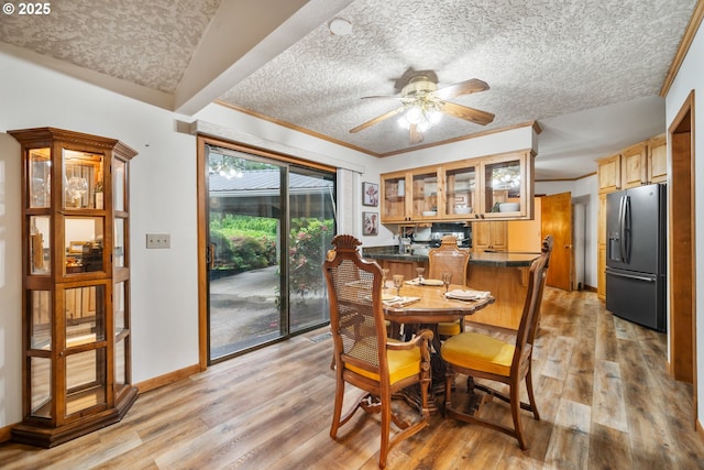 14000 NE 97th Ave, Vancouver, WA 98662 - dining area with a textured ceiling, light wood finished floors, a ceiling fan, baseboards, and crown molding