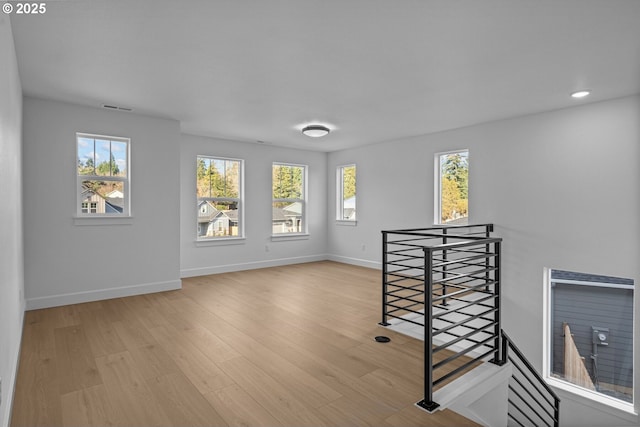 spare room featuring light hardwood / wood-style flooring and a wealth of natural light