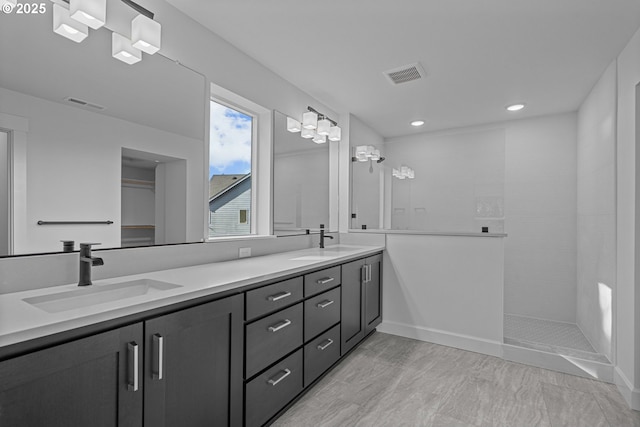 bathroom featuring vanity and a tile shower