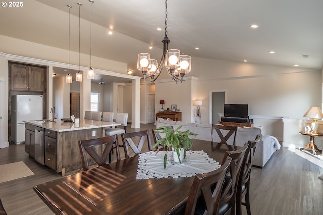 dining room featuring an inviting chandelier, vaulted ceiling, recessed lighting, and dark wood-style flooring