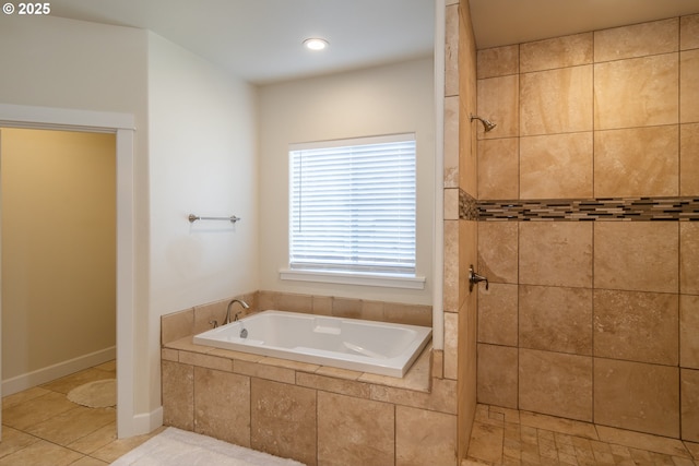 bathroom with a bath, tile patterned floors, and tiled shower