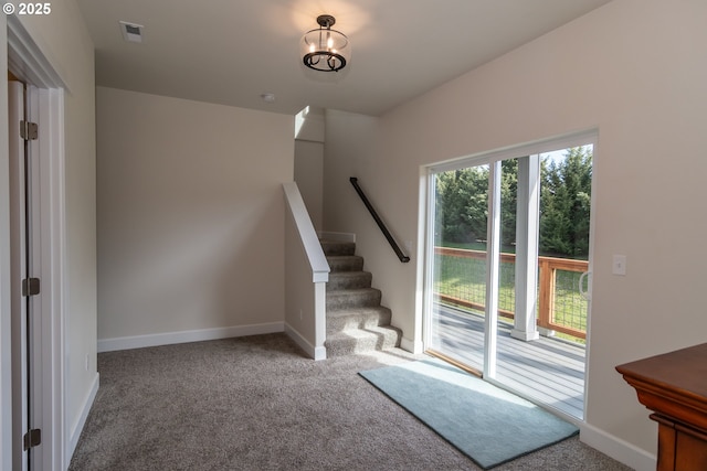 interior space with visible vents, baseboards, and carpet floors