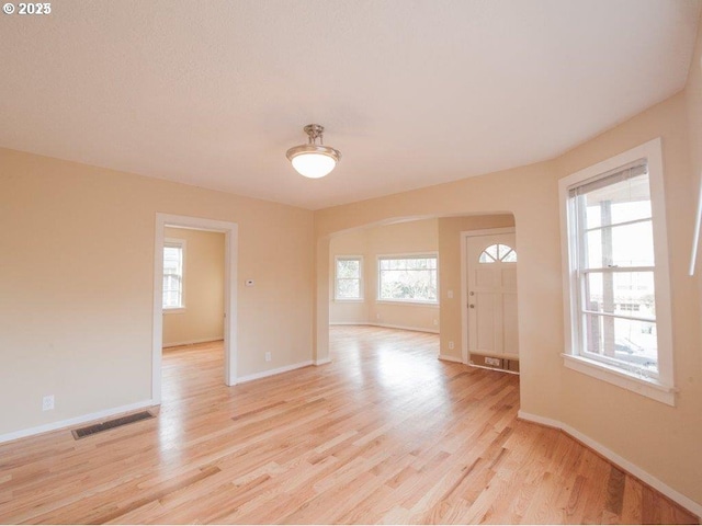 934 SE Nehalem St, Portland, OR 97202 - unfurnished room with arched walkways, light wood-type flooring, and baseboards