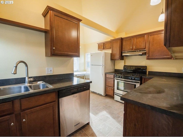 934 SE Nehalem St, Portland, OR 97202 - kitchen featuring appliances with stainless steel finishes, under cabinet range hood, a sink, dark countertops, and vaulted ceiling