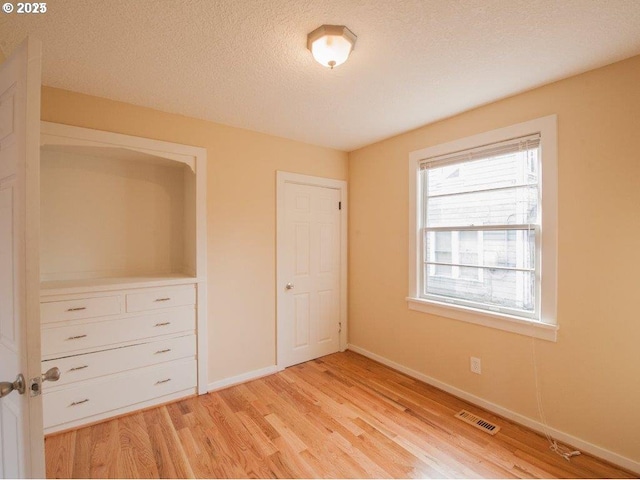 934 SE Nehalem St, Portland, OR 97202 - unfurnished bedroom with light wood-style flooring, baseboards, and a textured ceiling