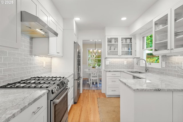 630 9th St, Lake Oswego, OR 97034 - kitchen featuring stainless steel appliances, under cabinet range hood, light wood-type flooring, white cabinets, and recessed lighting