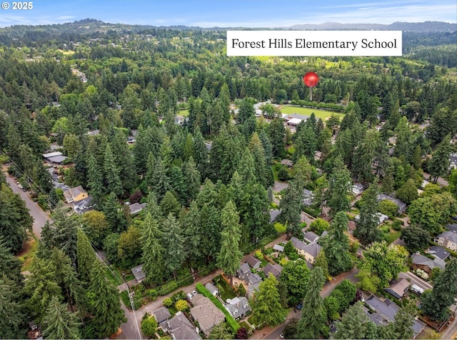 630 9th St, Lake Oswego, OR 97034 - aerial overview of property's location featuring a forest and mountains
