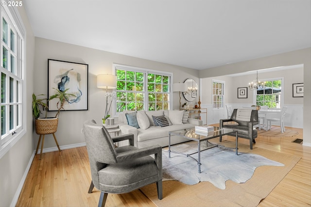 630 9th St, Lake Oswego, OR 97034 - living room with a chandelier, wood finished floors, healthy amount of natural light, and a wainscoted wall