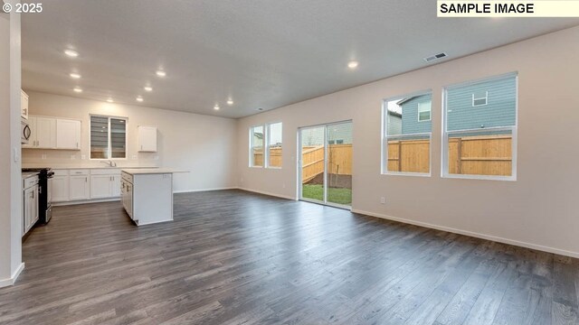 unfurnished living room featuring dark hardwood / wood-style flooring