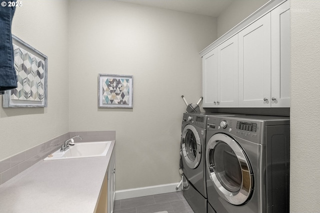 6435 SE Ketchum St, Milwaukie, OR 97267 - washroom featuring cabinet space, independent washer and dryer, baseboards, and dark tile patterned floors