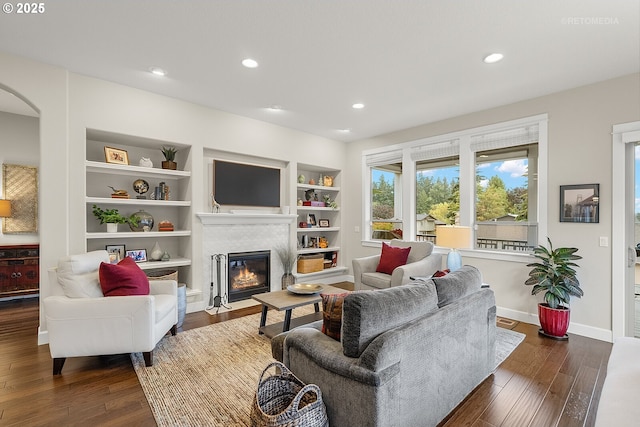 6435 SE Ketchum St, Milwaukie, OR 97267 - living area featuring a fireplace with flush hearth, dark wood-style floors, recessed lighting, baseboards, and arched walkways