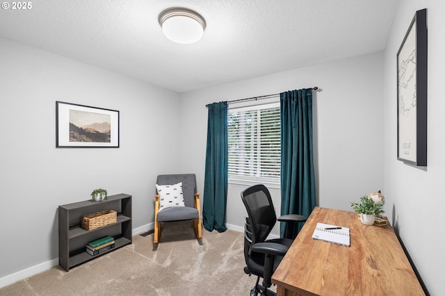 carpeted home office with baseboards and a textured ceiling