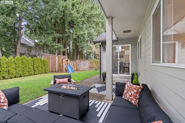 view of patio / terrace featuring an outdoor living space with a fire pit, a playground, fence, and visible vents