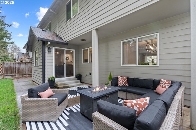 view of patio / terrace featuring entry steps, an outdoor living space with a fire pit, and fence