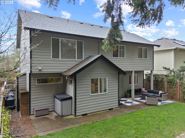 rear view of house with roof with shingles, fence, a yard, a patio area, and an outdoor living space