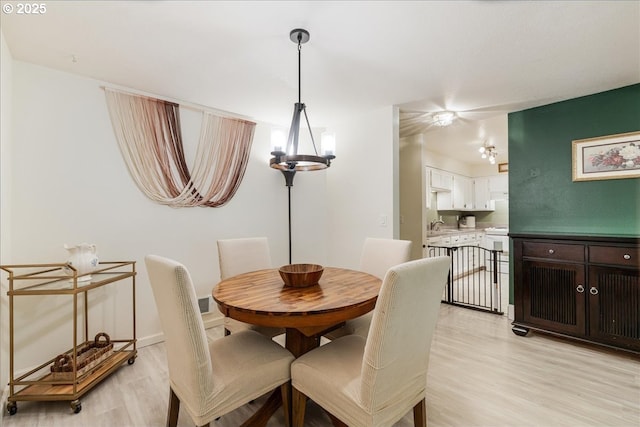 8720 SW Tualatin Rd Unit 204, Tualatin, OR 97062 - dining area with light wood-style floors and a chandelier