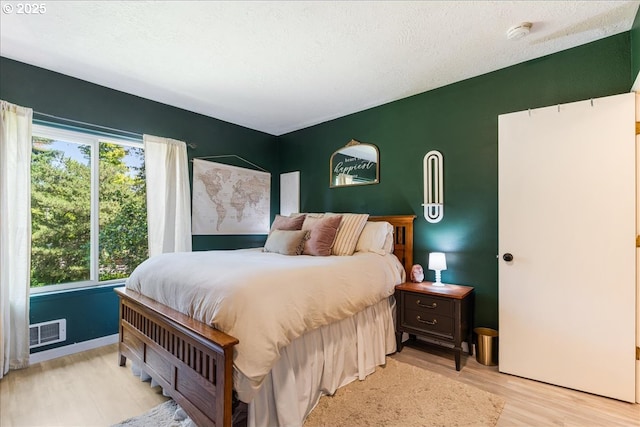 8720 SW Tualatin Rd Unit 204, Tualatin, OR 97062 - bedroom with multiple windows, light wood-style flooring, and a textured ceiling