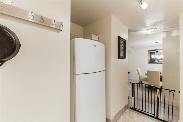 8720 SW Tualatin Rd Unit 204, Tualatin, OR 97062 - kitchen with freestanding refrigerator and light tile patterned floors