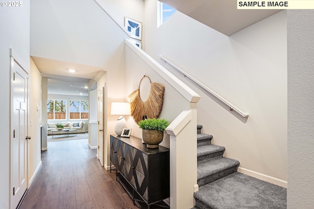23623 SW Landon Pl, Tualatin, OR 97062 - staircase featuring wood finished floors, baseboards, recessed lighting, and a high ceiling