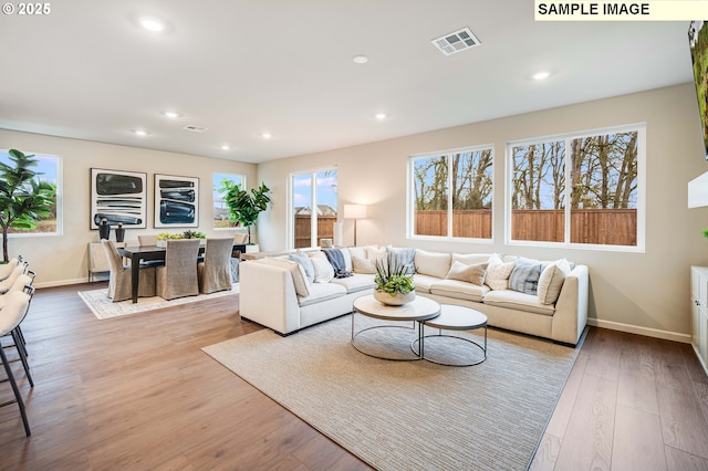 23623 SW Landon Pl, Tualatin, OR 97062 - living area featuring baseboards, wood finished floors, and recessed lighting