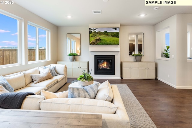 23623 SW Landon Pl, Tualatin, OR 97062 - living room with dark wood-style flooring, baseboards, recessed lighting, and a glass covered fireplace