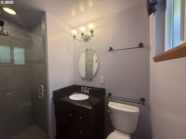 full bath featuring vanity, a stall shower, and toilet