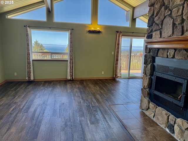 unfurnished living room with a wealth of natural light, wood finished floors, and a fireplace