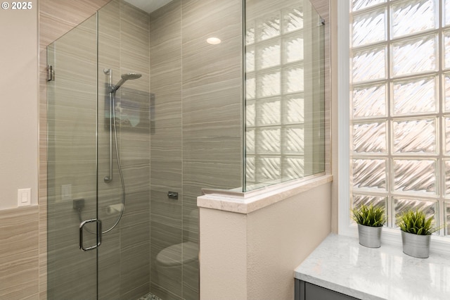 bathroom with a stall shower and vanity