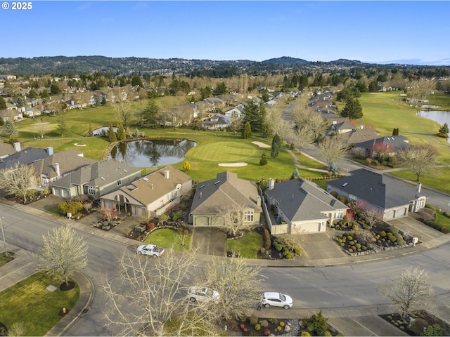 bird's eye view with golf course view, a water view, and a residential view