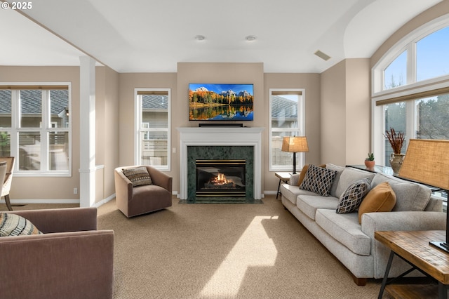 carpeted living room with a fireplace, visible vents, and baseboards