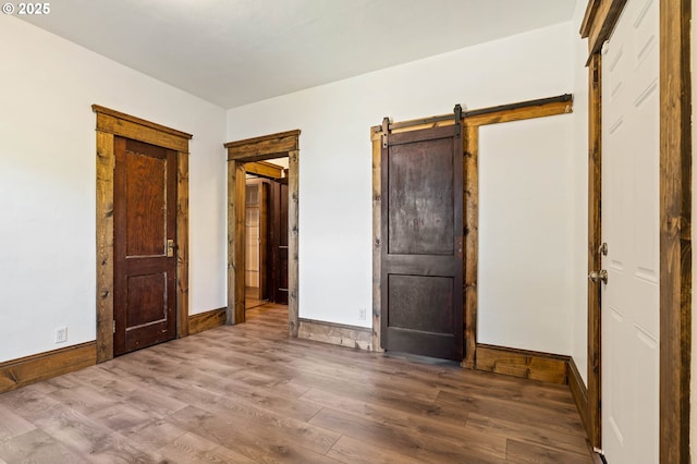 622 C St, Washougal, WA 98671 - unfurnished bedroom with wood finished floors and a barn door