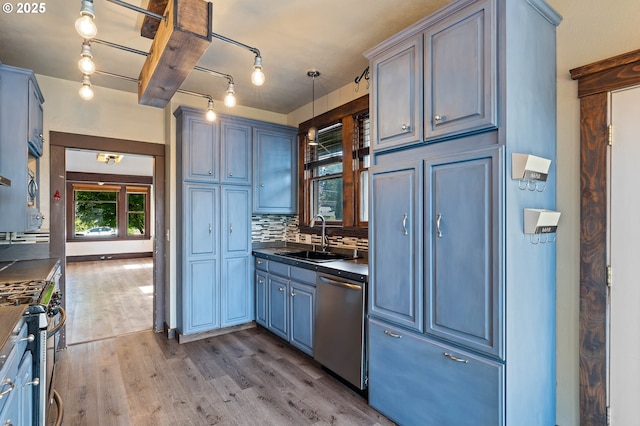 622 C St, Washougal, WA 98671 - kitchen featuring appliances with stainless steel finishes, dark countertops, wood finished floors, tasteful backsplash, and blue cabinetry