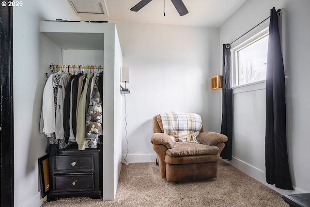 living area featuring carpet flooring, a ceiling fan, and baseboards