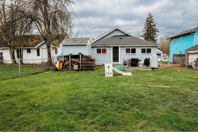 back of property featuring a fenced backyard, an outbuilding, and a yard