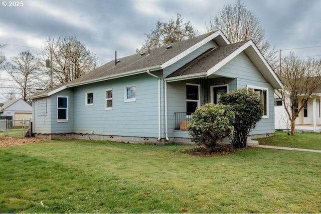 exterior space featuring a yard, crawl space, roof with shingles, and fence