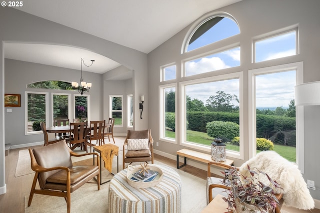 6600 NW Burgundy Dr, Corvallis, OR 97330 - living area with arched walkways, a chandelier, baseboards, light wood finished floors, and high vaulted ceiling