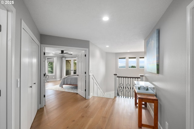 6600 NW Burgundy Dr, Corvallis, OR 97330 - corridor with an upstairs landing, light wood-style flooring, healthy amount of natural light, recessed lighting, and baseboards