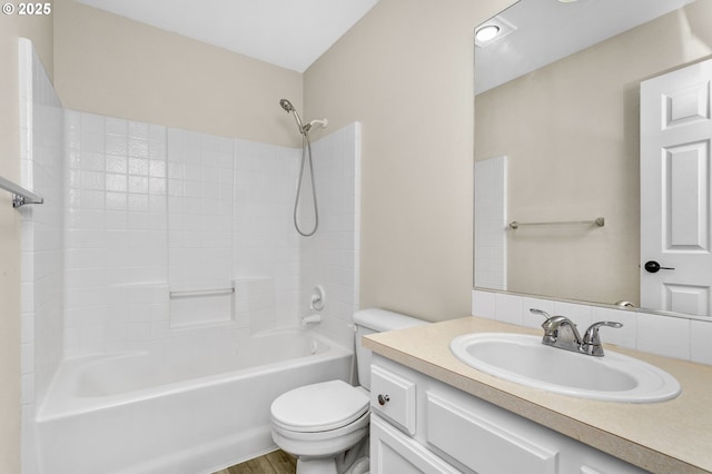 bathroom with toilet, shower / bathtub combination, and vanity