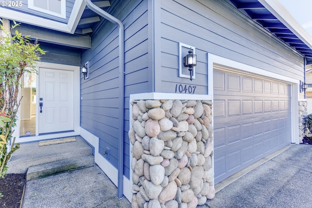 view of exterior entry with a garage