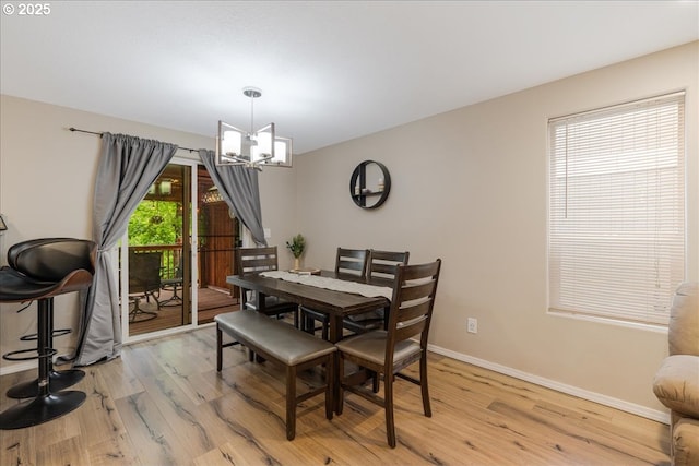 525 SW 207th Ave, Beaverton, OR 97006 - dining space with a chandelier, light wood finished floors, and baseboards