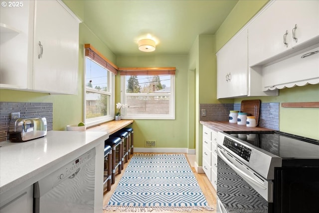 kitchen featuring tasteful backsplash, stainless steel electric range, white cabinets, light countertops, and dishwashing machine