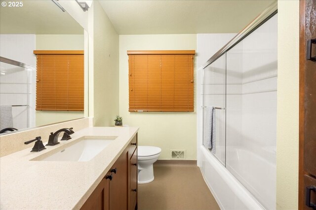 full bathroom featuring visible vents, combined bath / shower with glass door, toilet, and vanity