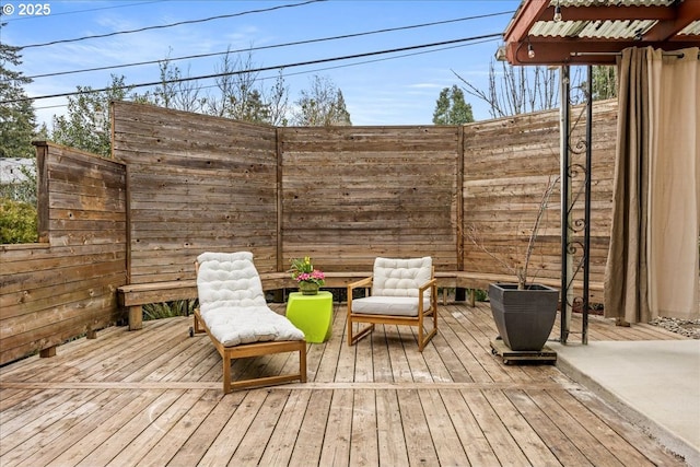 wooden terrace featuring fence