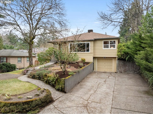 view of front of property featuring stucco siding, driveway, an attached garage, a shingled roof, and a chimney