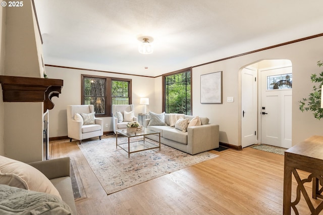 5932 NE 29th Ave, Portland, OR 97211 - living room with arched walkways, baseboards, light wood-type flooring, and crown molding