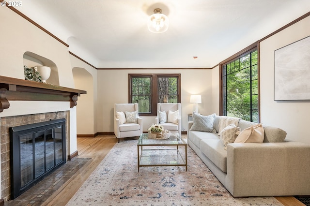 5932 NE 29th Ave, Portland, OR 97211 - living room featuring a fireplace with flush hearth, wood finished floors, healthy amount of natural light, baseboards, and ornamental molding