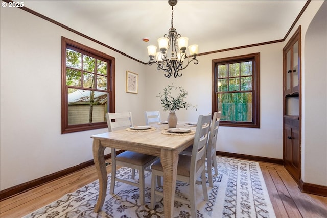 5932 NE 29th Ave, Portland, OR 97211 - dining area featuring a chandelier, light wood-type flooring, baseboards, and crown molding