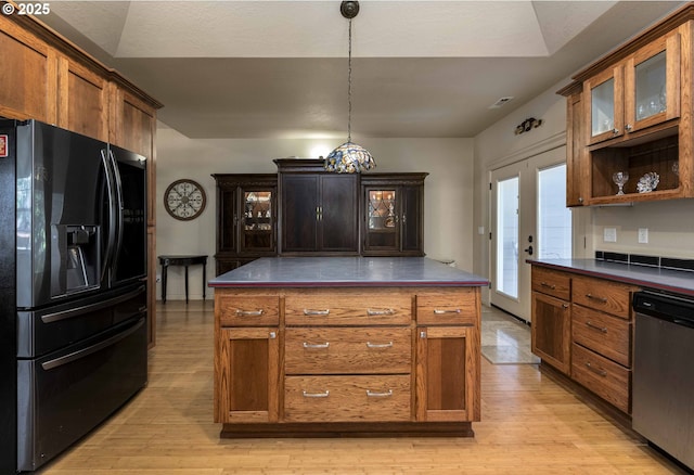 6783 Rogue River Dr, Shady Cove, OR 97539 - kitchen with black fridge, dishwasher, light wood-style flooring, and glass insert cabinets