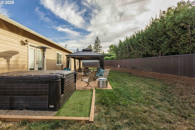 6783 Rogue River Dr, Shady Cove, OR 97539 - fenced backyard featuring a hot tub, a gazebo, and a patio area